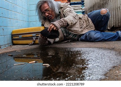 Selective Focus Addiction Aged Man Sitting On Dirty Street With Old Blanket Excited With Money Donation, Unemployed Homeless Get Cold Need Help For Medical Care, Abandoned Poverty Begging For Money.