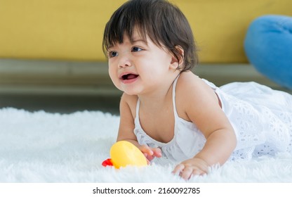 Selective Focus Adorable Caucasian Little Baby Daughter Girl, Crying, Angry, Crawling On The Floor, Playing Alone In Comfortable Living Room At Home. Kid Development Concept