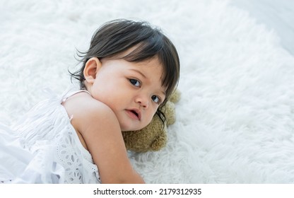 Selective Focus Adorable Caucasian Little Baby Daughter Girl, Smiling, Crawling On The Floor, Playing Alone In Comfortable Living Room At Home Or House With Happiness. Kid Development Concept