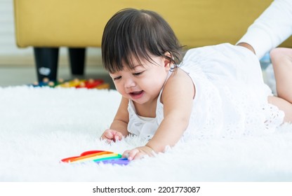 Selective Focus Adorable Caucasian Little Baby Daughter Girl, Crying, Angry, Crawling On The Floor, Playing Alone In Comfortable Living Room At Home. Kid Development Concept