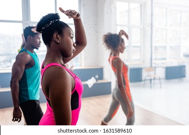 Selective Focus Of African American Dancers Practicing Zumba With Trainer In Dance Studio