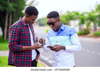 selective focus of african guys with smart phone- outdoor communication concept