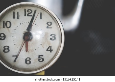 Selective Focus Of Alarm Clock On Side Table Beside Bed Show 6 O'clock In The Morning Background.Time In Life Early Bird Person Productive Concept.