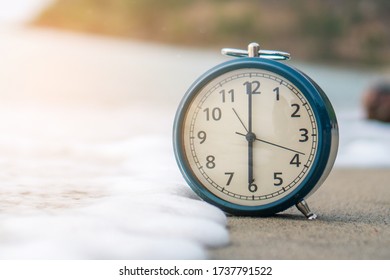 Selective Focus Of Alarm Clock On Side Table Beside Bed Show 6 O'clock In The Morning Background.Time In Life Early Bird Person Productive Concept.