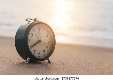 Selective Focus Of Alarm Clock On Side Table Beside Bed Show 8 O'clock In The Morning Background.Time In Life Early Bird Person Productive Concept.