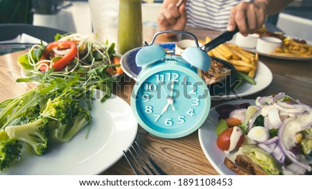 Selective focus of Alarm clock which Time to lose weight and  eating control or time to diet concept 