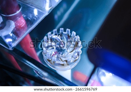 Selective focus of an aquarium surface skimmer submerged in water. The transparent plastic device removes debris and organic film from the water surface, keeping the aquarium clean and clear.