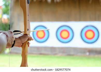 Selective focus of Archer holds his bow aiming at a target. - Powered by Shutterstock