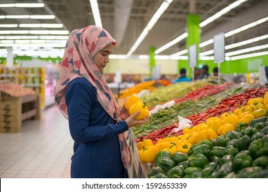 Selective Focus Asian Adult Woman Do Grocery Shopping At Supermarket.