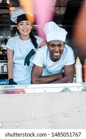 Selective Focus Of Asian Girl Standing Near African American Man In Food Truck 