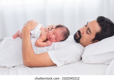 Selective Focus Of Asian Newborn Baby Sleeping On His Father's Chest. Dad And Son Spend Time Together At Home, Young Dad With Cute Little Infant In His Arms. Father And Toddler In Bed In The Morning