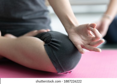 Selective Focus Of Asian Woman Sit On Pink Yoga Exercise Mat Pose Lotus Hand Practicing Meditation. Clam And Relaxation Concept. 