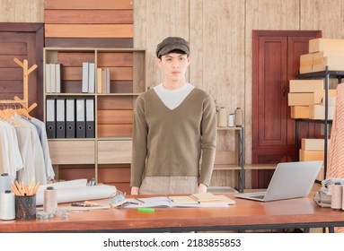 Selective Focus Of Asian Young Man Smiling Asian Wear Hat Stand Confident Small Business Entrepreneur Fashion Designer At Workplace. Designer Clothing Concepts For Sale Online. 