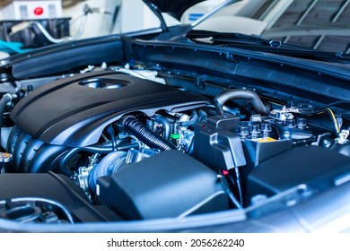 Selective focus to automotive industrial part of modern new car engine room, Machine show all parts and open hood. Engine room of new car.