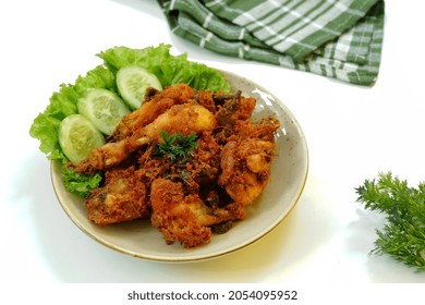Selective focus Ayam Goreng Lengkuas or or Ayam Serundeng or Galangal Fried Chicken with Curry leaves as Indonesian food. Served on white background. Look like noised with ayam serundeng. 
