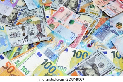 Selective focus of a background of gulf middle eastern money of Saudi Arabia riyals, Emirates Dirhams and Kuwaiti Dinars with American dollars and European euros banknotes, exchange rate money concept