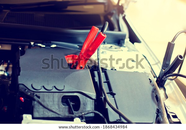Selective focus to battery cable\
connector in car engine room for  maintenance service. Automotive\
power processing for maintenance car in service\
center.
