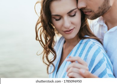selective focus of bearded man holding hands with attractive girl