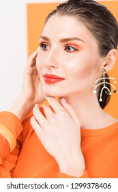 Selective Focus Of Beautiful Fashionable Young Woman Posing With Tumeric On Background