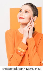 Selective Focus Of Beautiful Fashionable Young Woman Posing With Tumeric On Background