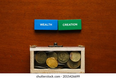 Selective Focus Of Blue And Wooden Domino Written Wealth Creation With Gold Chest Insight.