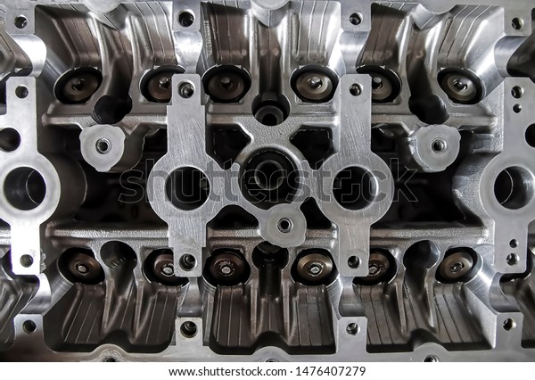 Selective focus. Blurred.\
Grain. noise. Disassembled the cylinder head engine and fragment of\
valves closeup