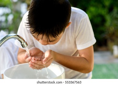 Selective Focus Brand New Faucet And Kid Hand Taking Water To Wash.