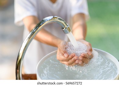 Selective Focus And Brand New Faucet And Kid Hand Taking Water.