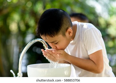 Selective Focus Brand New Faucet And Kid Hand Taking Water To Wash.