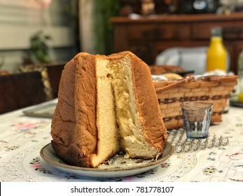 Selective focus Breakfast set on the table,cut loaf panettone bread,orange juice and wooden basket