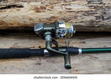 selective focus of broken fishing rod on a wooden block - Powered by Shutterstock