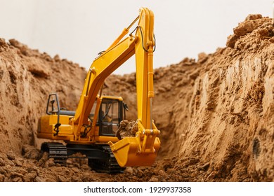 Selective focus ,bucket of excavators are digging the soil in the construction site with  on white background