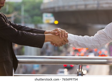 Selective Focus The Business Trust Commitment Which Business Partners Holding Hands,Help, Trust ,support And Factors Relationship Marketing For Reach Successful Achievement,Trust And Commit Concept.