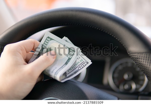 Selective focus Car\
key in hand and cash money in other hand of bill, Money to repair\
the car. Financial\
concept.