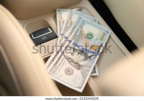 Selective focus Car\
key in hand and cash money in other hand of bill, Money to repair\
the car. Financial\
concept.