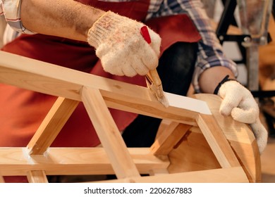 Selective focus, Carpenter painting on wooden chair furniture with a paintbrush. Craftsman and DIY handmade. - Powered by Shutterstock