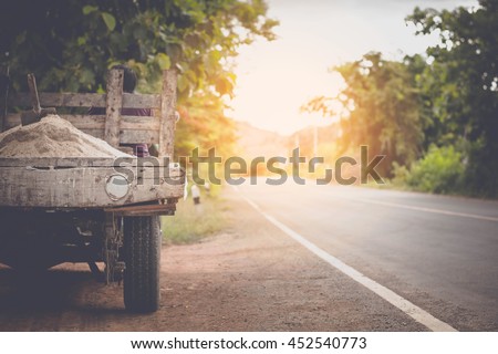 Selective focus a cart and its driver on a road of Thailand.copy space