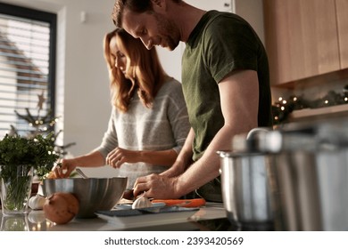 Selective focus of caucasian couple cooking together  before Christmas in domestic kitchen - Powered by Shutterstock