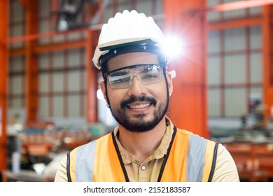 Selective Focus At Caucasian Men Engineer Supervisor, Wearing Safety Equipment. While Doing Audit For Quality And Safety Control Inside Of Factory Area. With Blurred Background Of Heavy Machine.
