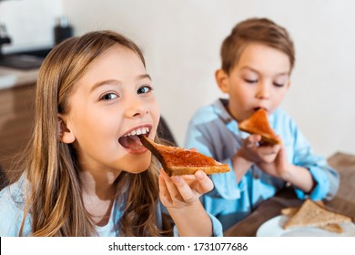 Selective Focus Of Cheerful Siblings Eating Toast Bread With Bread