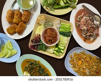 Selective Focus Of Chili Paste With Shrimp Served With Fried Rice, Spicy Oyster Salad, Deep Fried Crab Spring Roll And Cockles With Betel Leaves Curry