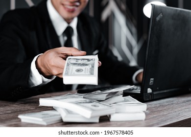 Selective focus. Close up of businessman hand offering batch of hundred dollar bills.Venality, bribe, corruption concept.  - Shutterstock ID 1967578405