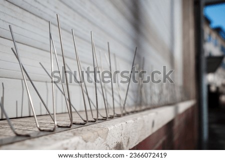 Selective focus and close up detail of Gutter Spikes for Birds, protect bird to nest and roost on the windows. 