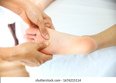 Selective Focus And Close Up Masseuse Use Thump Press On Sole Of Young Female For Blood Circulation And Fatigue, Spa Massage Concept, Copy Space