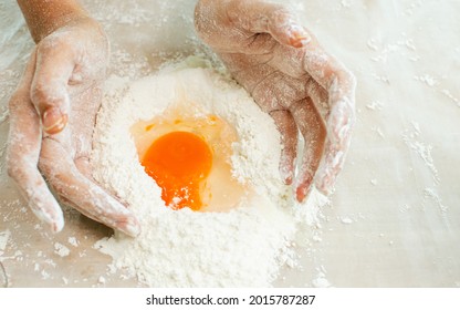 Selective Focus And Close Up On Hands Teaching, Showing And Threshing Dough Flour With Egg Inside To Make Pie For Serving On Table In Kitchen At Home. Restaurant, Bakery, Hobby And Lifestyle Concept