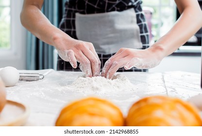 Selective Focus And Close Up On Hands Teaching, Showing And Threshing Dough Flour With Egg Inside To Make Pie For Serving On Table In Kitchen At Home. Restaurant, Bakery, Hobby And Lifestyle Concept