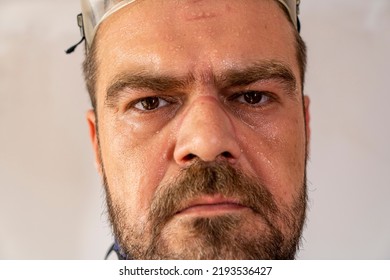 Selective Focus, Close Up Shot Of Sweaty, Exhausted Man Face With Safety Equipment Marks.