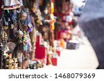(Selective focus) Close-up view of some souvenirs (singing bowls, hand created statues and Rudraksha necklace) on a street market stall in Kathmandu Durbar Square, Kathmandu, Nepal.