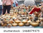 (Selective focus) Close-up view of some souvenirs (singing bowls, hand created statues and Rudraksha necklace) on a street market stall in Kathmandu Durbar Square, Kathmandu, Nepal.