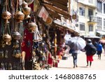 (Selective focus) Close-up view of some souvenirs (singing bowls, hand created statues and Rudraksha necklace) on a street market stall in Kathmandu Durbar Square, Kathmandu, Nepal.